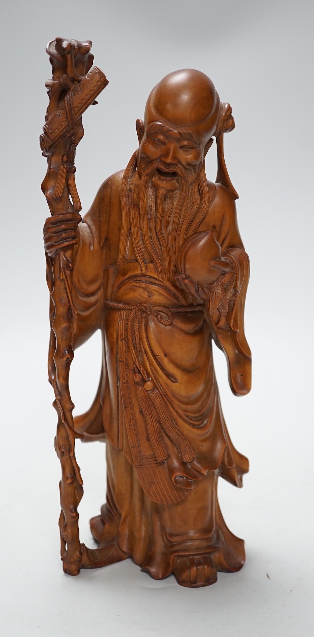 An early 20th century Chinese carved boxwood figure of Shou Lao, 26cm